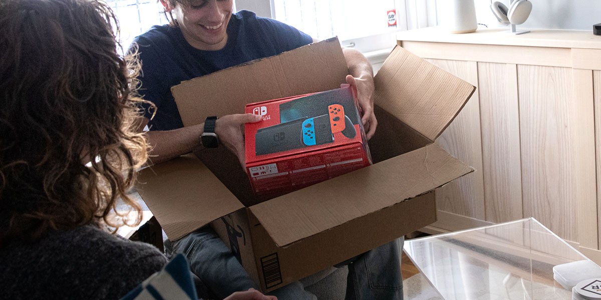 Person removing Nintendo Switch from box