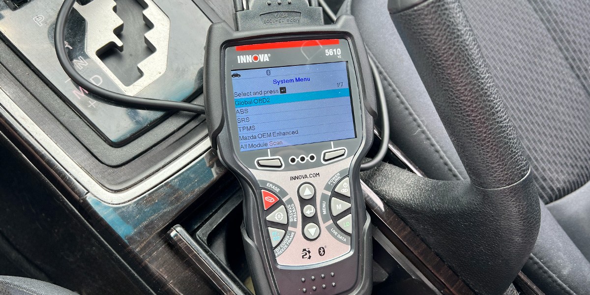 Innova Bidirectional Scan Tool in use inside car Innova Bidirectional Scan Tool in use inside car