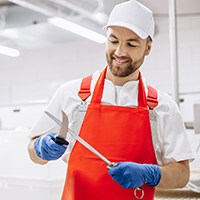 a man sharpening a boning knife