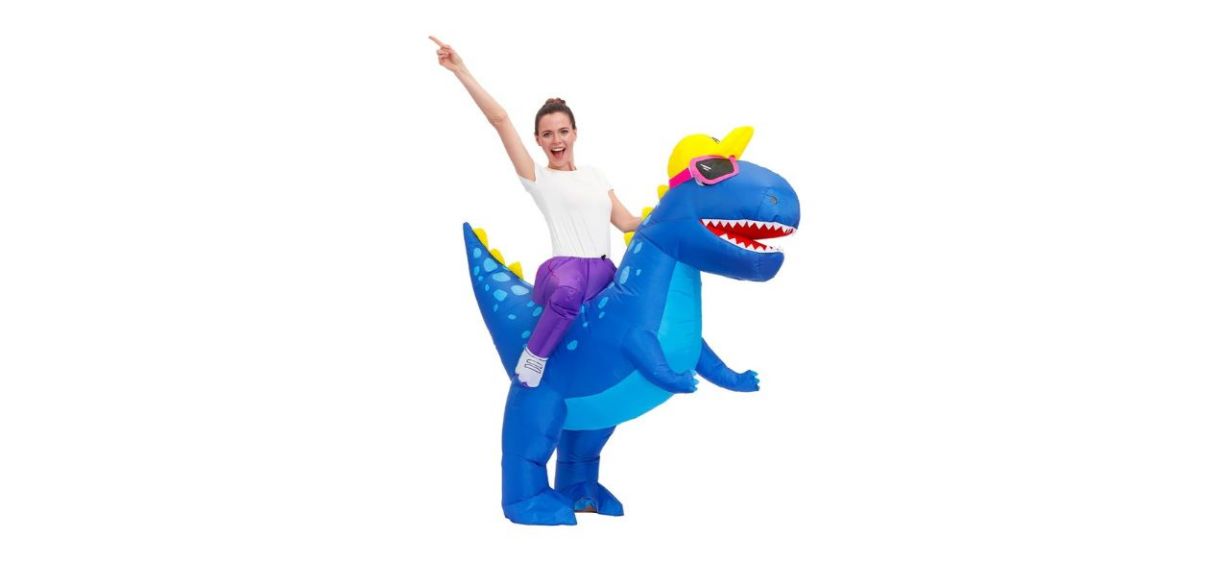 woman wearing blue dinosaur inflatable costume that looks like she's riding on the back of it